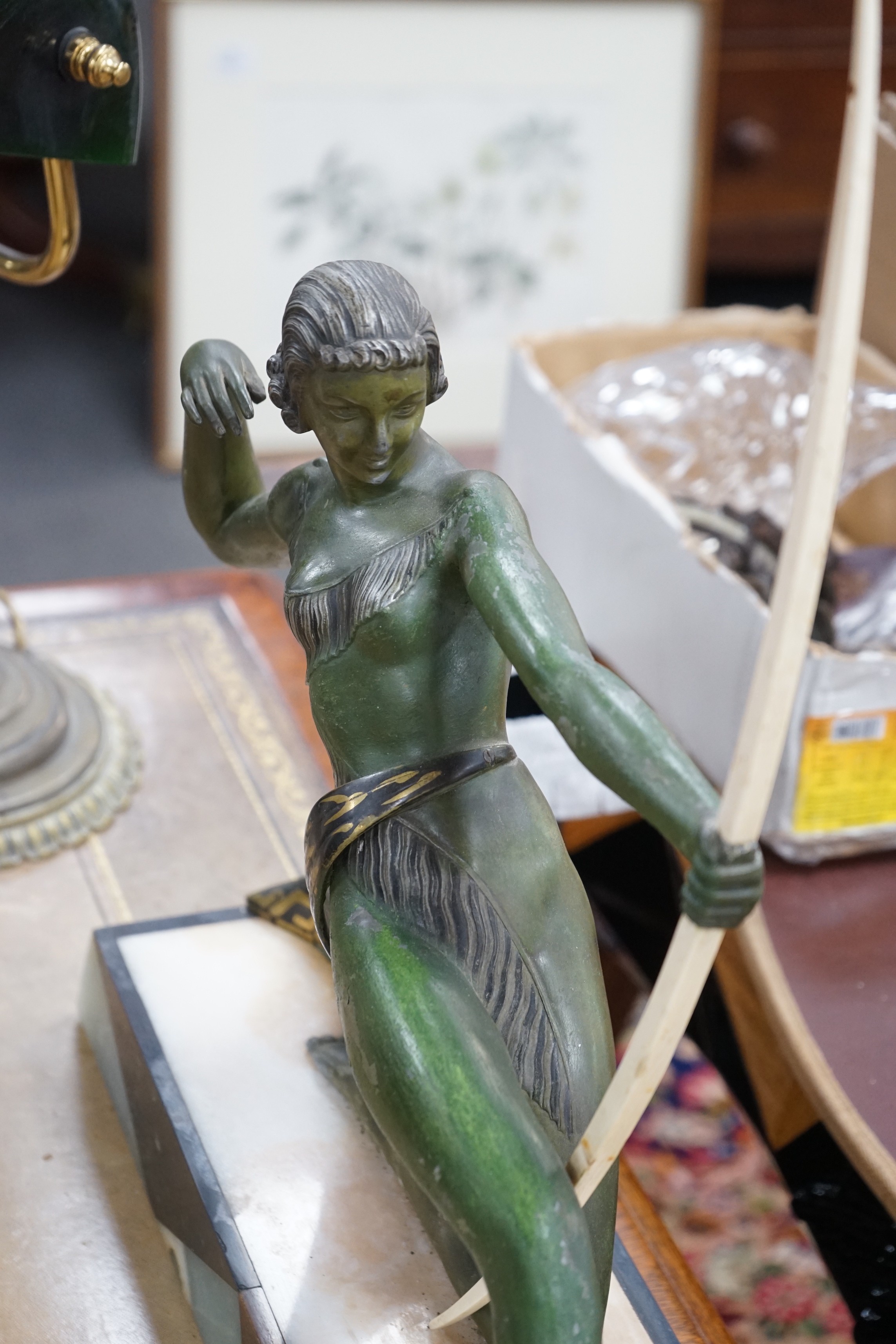 A French Art Deco spelter bronzed model of Diana The Huntress, with ornate marble base, after Uriano. 49cm wide